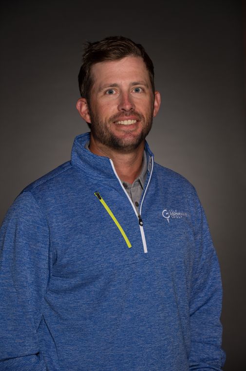 JJ Wood, PGA, wearing a blue Golf Performance Group pullover