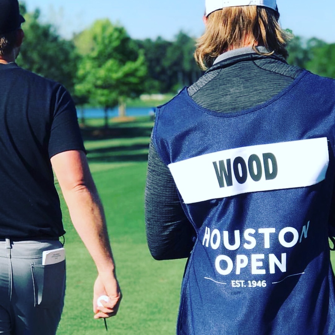 JJ Wood at left walking with his caddie at the Houston Open